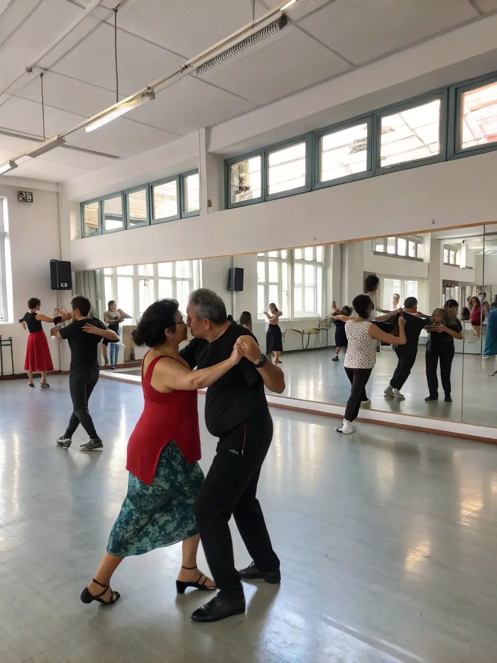 A photograph of a dance workshop in session at La Maline, with participants of all ages learning various dance styles from a professional instructor. The atmosphere is energetic and inclusive.